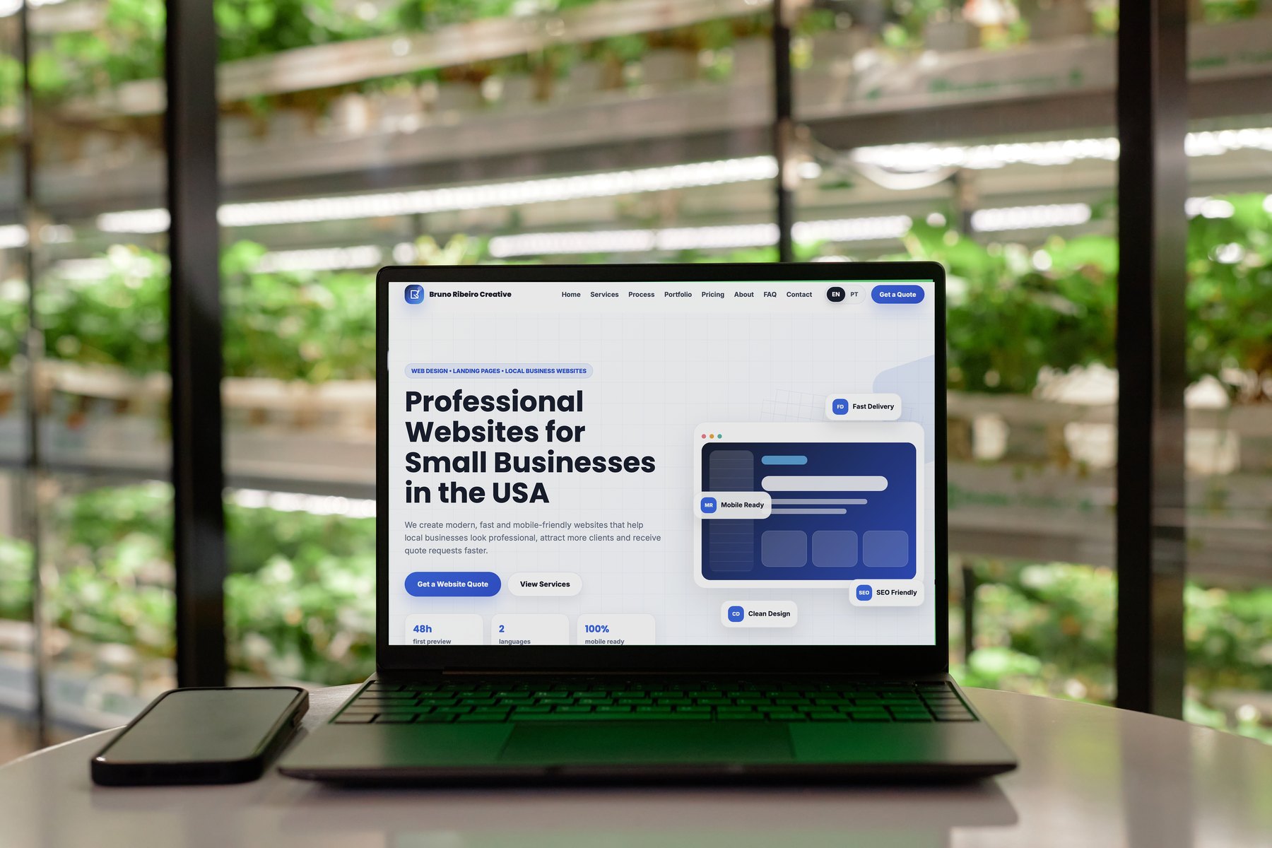 Laptop displaying the Bruno Ribeiro Creative website in an indoor garden workspace